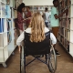 disabled girl on wheelchair in library