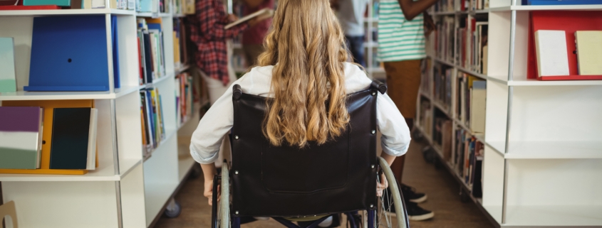 disabled girl on wheelchair in library